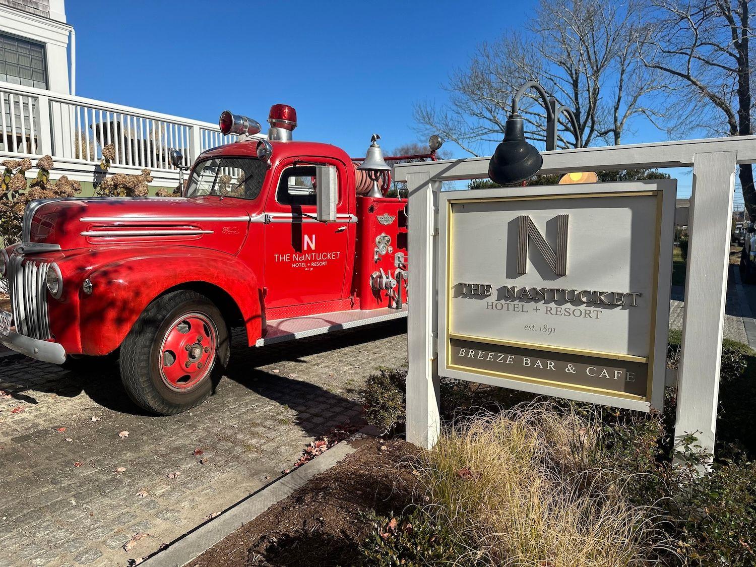 Red old truck next to the Nantucket Resort sign.